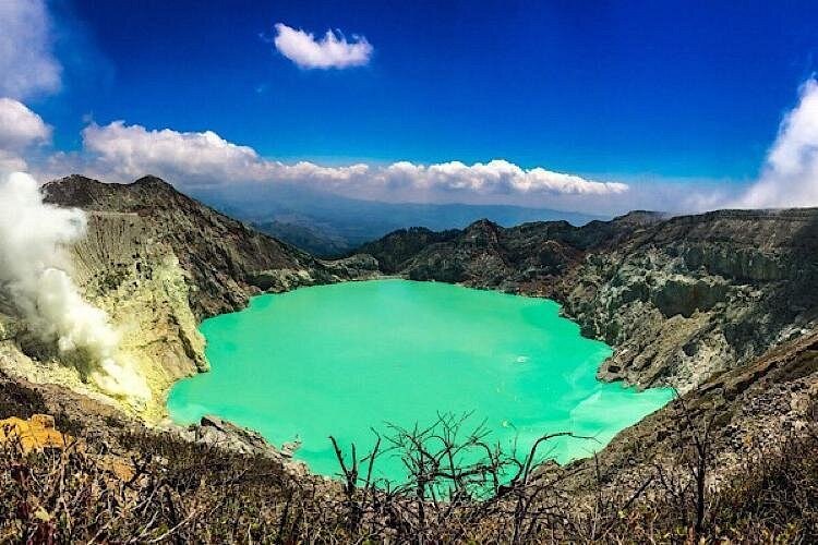 The crater lake and the sheer inner wall of Kawah Ijen from the rim path